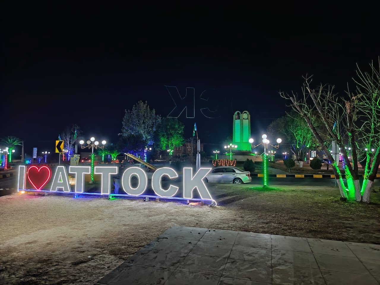 Attock at night with the I Love Attock landmark and illuminated public square